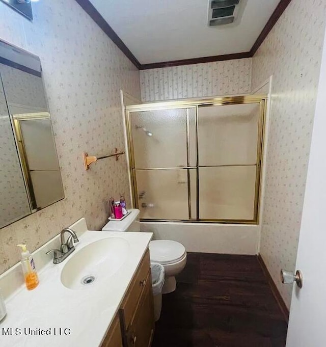 full bathroom featuring hardwood / wood-style floors, vanity, toilet, and crown molding