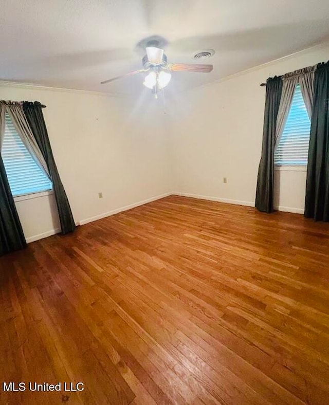 unfurnished room with ceiling fan, wood-type flooring, and ornamental molding