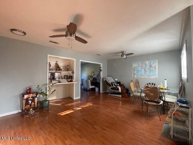 miscellaneous room featuring dark wood-type flooring and ceiling fan