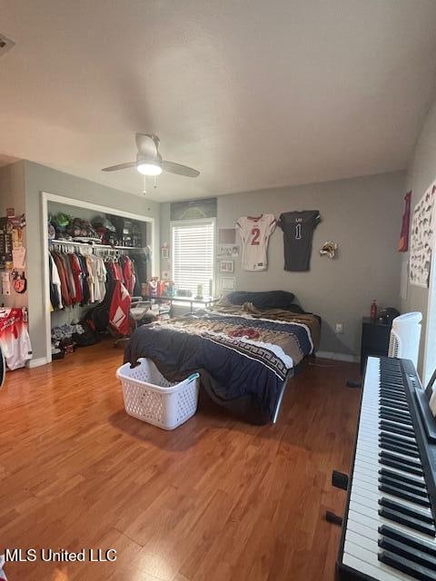 bedroom featuring wood-type flooring, a closet, and ceiling fan