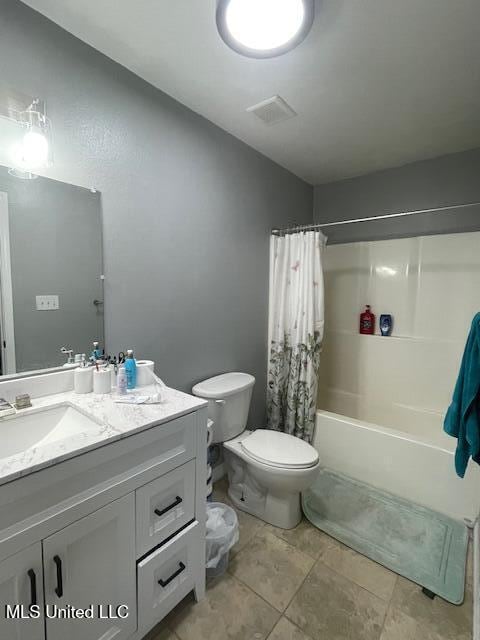 full bathroom featuring toilet, shower / bath combo with shower curtain, vanity, and tile patterned floors