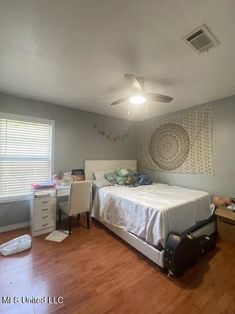 bedroom featuring ceiling fan and hardwood / wood-style flooring