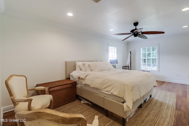 bedroom with ornamental molding, hardwood / wood-style flooring, and ceiling fan