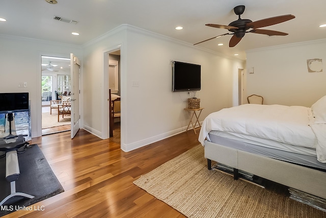 bedroom with ornamental molding, hardwood / wood-style flooring, and ceiling fan