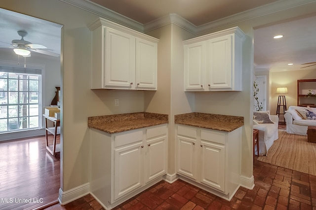 1 Bayou View Dr, Gulfport, MS 39507 - kitchen featuring ceiling fan, white cabinets, crown molding, dark stone countertops, and recessed lighting