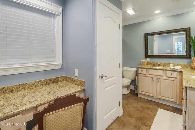 bathroom featuring toilet, crown molding, and vanity