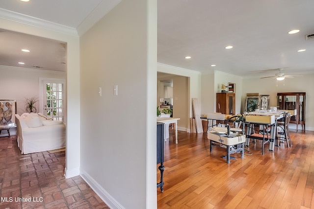 dining space featuring ceiling fan, hardwood / wood-style flooring, and ornamental molding