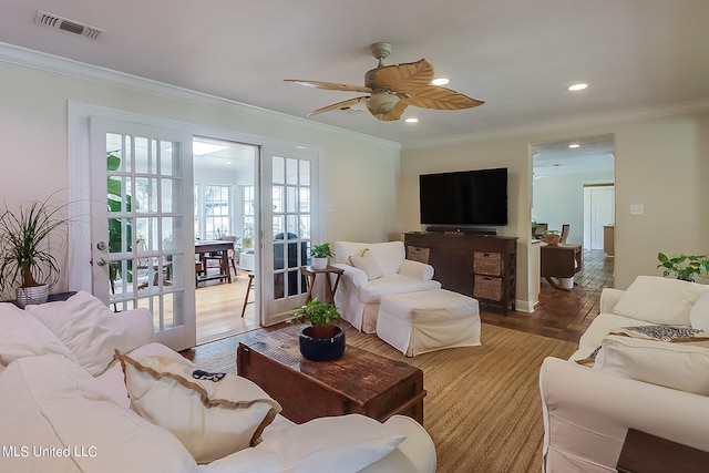 living room with hardwood / wood-style floors, crown molding, french doors, and ceiling fan