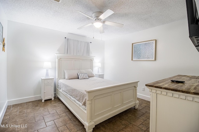 204 Trautman Ave, Long Beach, MS 39560 - bedroom with stone tile floors, a textured ceiling, and ceiling fan