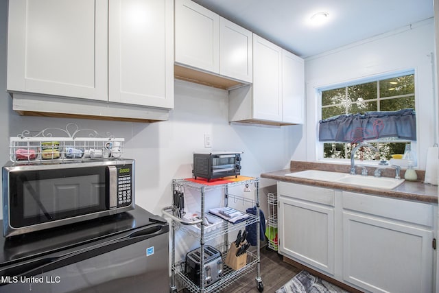204 Trautman Ave, Long Beach, MS 39560 - kitchen featuring stainless steel microwave, fridge, white cabinets, and dark wood finished floors