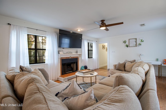 204 Trautman Ave, Long Beach, MS 39560 - living area featuring light wood finished floors, a ceiling fan, and a fireplace