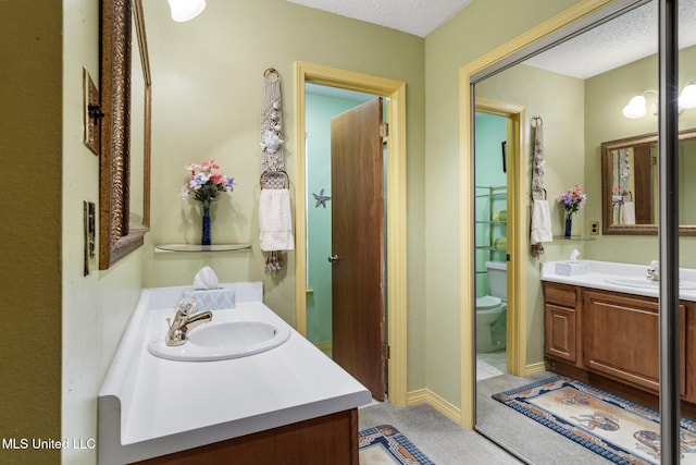 2804 Oakridge Cir, Gulfport, MS 39507 - bathroom featuring vanity, toilet, and a textured ceiling