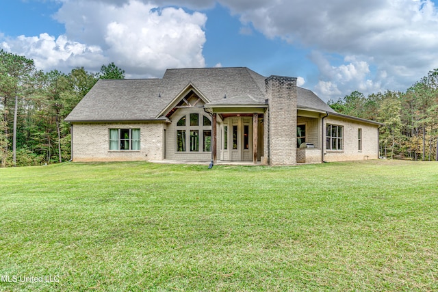 back of property featuring a lawn