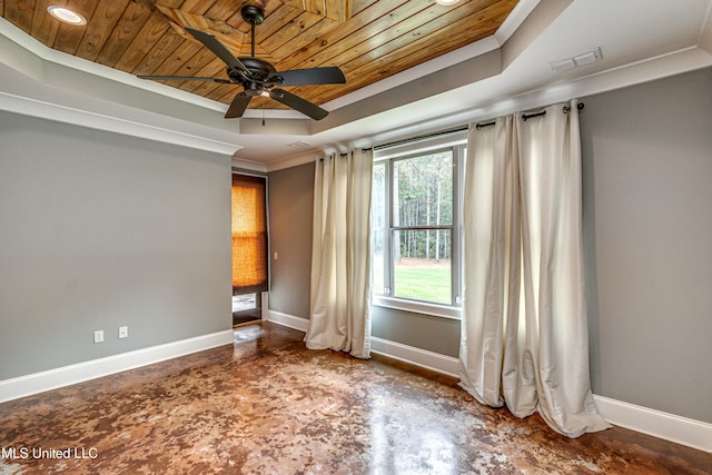 empty room with a raised ceiling, ceiling fan, crown molding, and wood ceiling