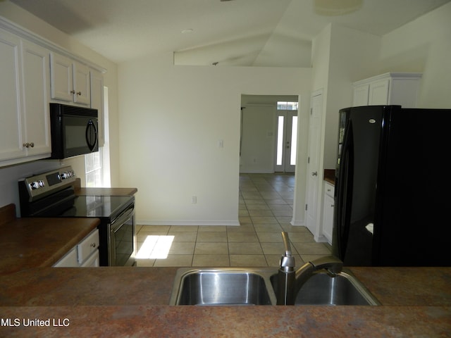 kitchen featuring black appliances, light tile patterned floors, white cabinetry, and a sink