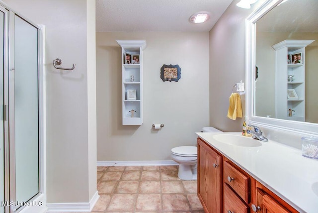 full bath with double vanity, baseboards, toilet, a shower stall, and a sink