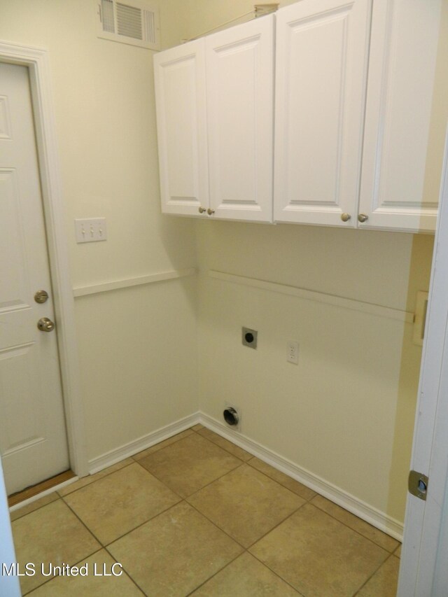 washroom featuring cabinet space, visible vents, electric dryer hookup, and tile patterned floors