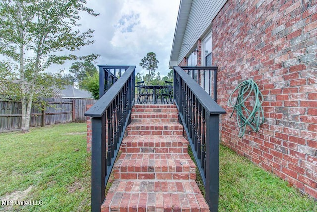 exterior details featuring fence and brick siding