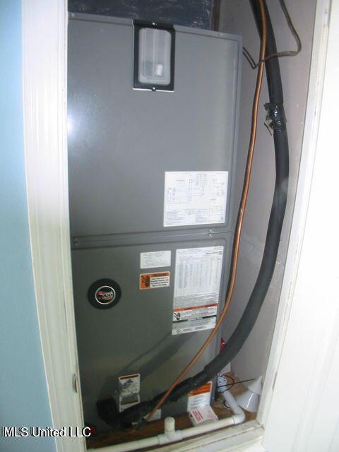 utility room with heating unit