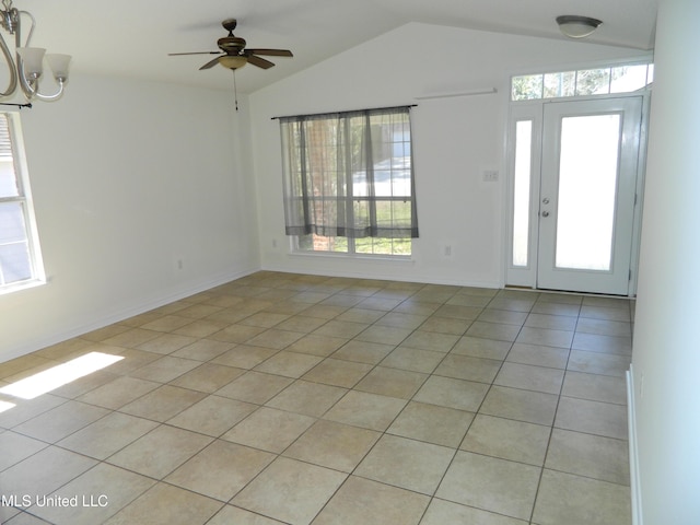 foyer entrance with vaulted ceiling, light tile patterned flooring, a ceiling fan, and baseboards