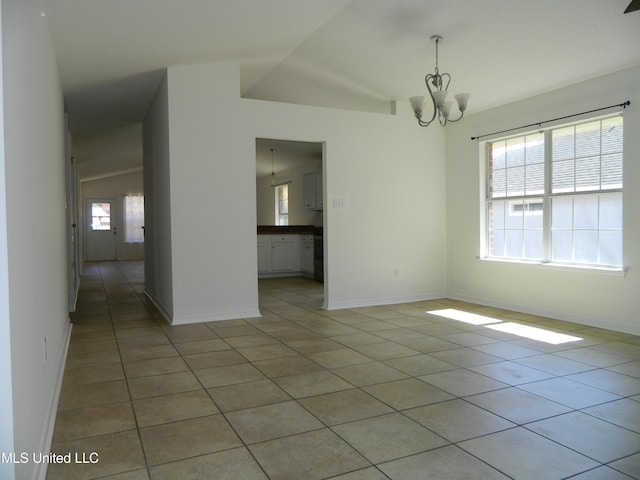 spare room featuring baseboards, a notable chandelier, and light tile patterned flooring