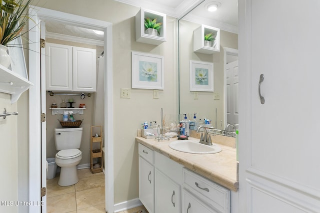 bathroom featuring toilet, ornamental molding, vanity, and tile patterned flooring