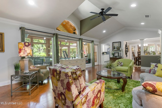 living room with lofted ceiling, ceiling fan, hardwood / wood-style flooring, decorative columns, and ornamental molding