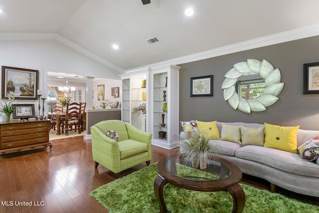 living room with lofted ceiling, dark wood-type flooring, a notable chandelier, and ornamental molding