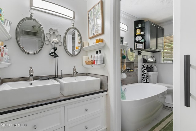 bathroom featuring toilet, tile patterned flooring, a bathtub, crown molding, and vanity