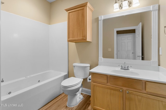 full bathroom with toilet, vanity, wood-type flooring, and washtub / shower combination