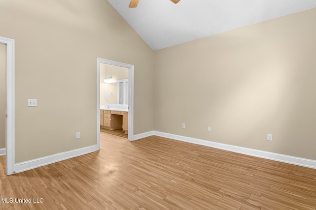 unfurnished bedroom with high vaulted ceiling, connected bathroom, light wood-type flooring, and ceiling fan