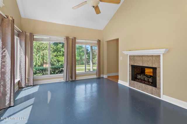 unfurnished living room with concrete flooring, high vaulted ceiling, a fireplace, and ceiling fan