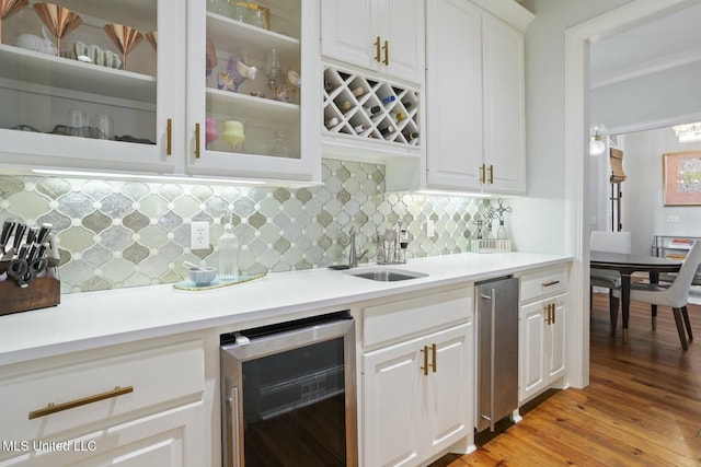 133 Saddlebrook Cv, Madison, MS 39110 - bar with beverage cooler, backsplash, a sink, light wood-style floors, and crown molding