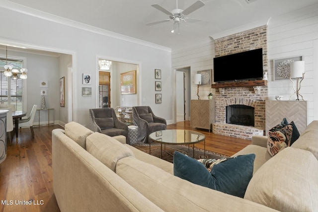 133 Saddlebrook Cv, Madison, MS 39110 - living room featuring ceiling fan with notable chandelier, crown molding, wood finished floors, and plenty of natural light