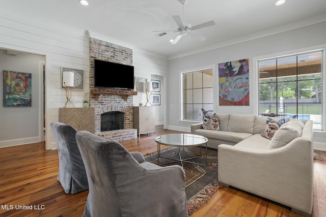 133 Saddlebrook Cv, Madison, MS 39110 - living area featuring wood finished floors, ceiling fan, baseboards, ornamental molding, and a brick fireplace