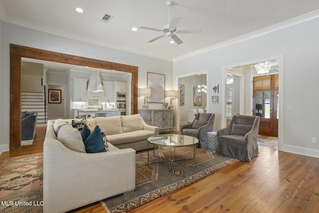 133 Saddlebrook Cv, Madison, MS 39110 - living area featuring wood finished floors, ceiling fan with notable chandelier, ornamental molding, visible vents, and recessed lighting
