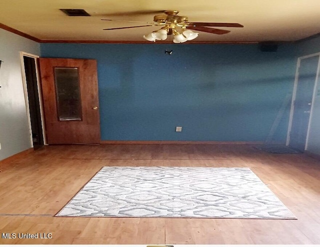 empty room featuring light hardwood / wood-style flooring, ceiling fan, and crown molding