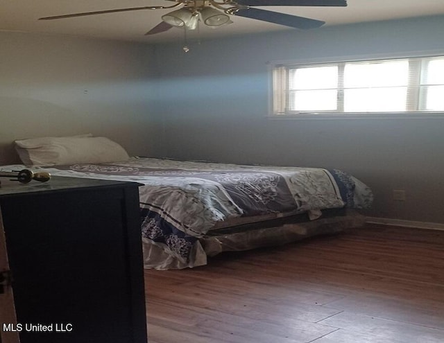 bedroom with ceiling fan and hardwood / wood-style flooring