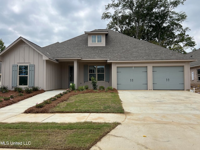 view of front facade with a garage and a front lawn