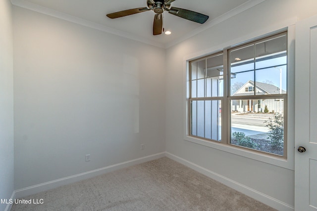 carpeted empty room with ceiling fan and ornamental molding