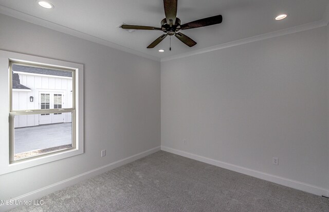 carpeted empty room with crown molding and ceiling fan