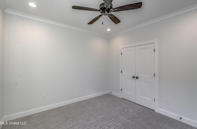 carpeted empty room with ceiling fan and ornamental molding