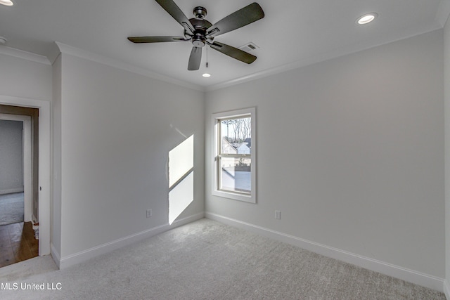 carpeted empty room featuring ceiling fan and crown molding