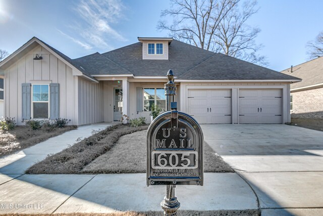 605 Cobalt Way, Brandon, MS 39042 - view of front of property with board and batten siding, a shingled roof, driveway, and a garage