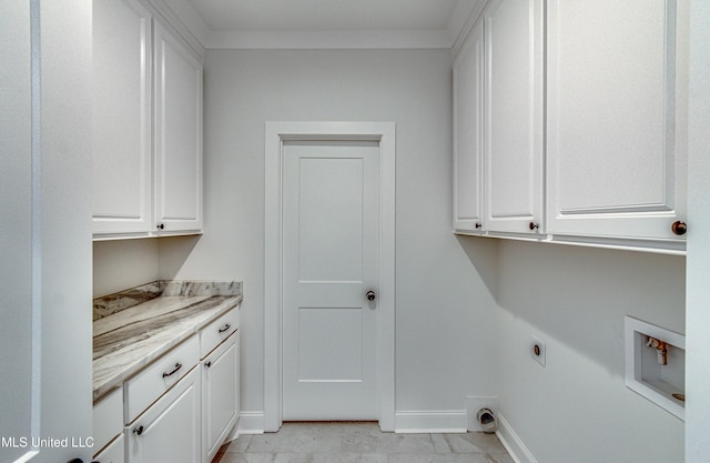 washroom featuring hookup for a washing machine, electric dryer hookup, and cabinets