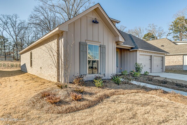 605 Cobalt Way, Brandon, MS 39042 - view of front of property with brick siding, an attached garage, driveway, and board and batten siding