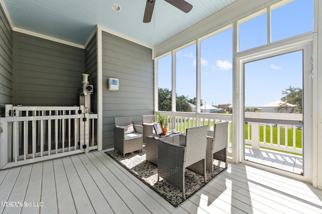 sunroom / solarium featuring ceiling fan