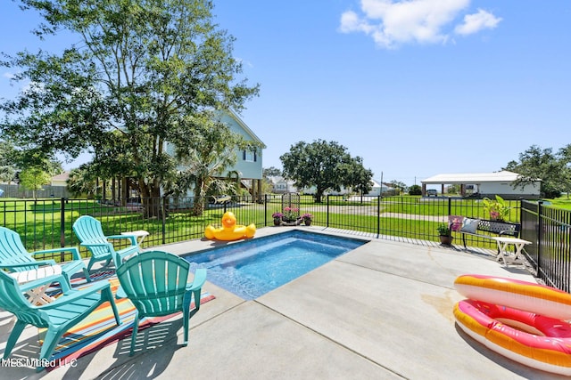 view of swimming pool featuring a patio area and a yard