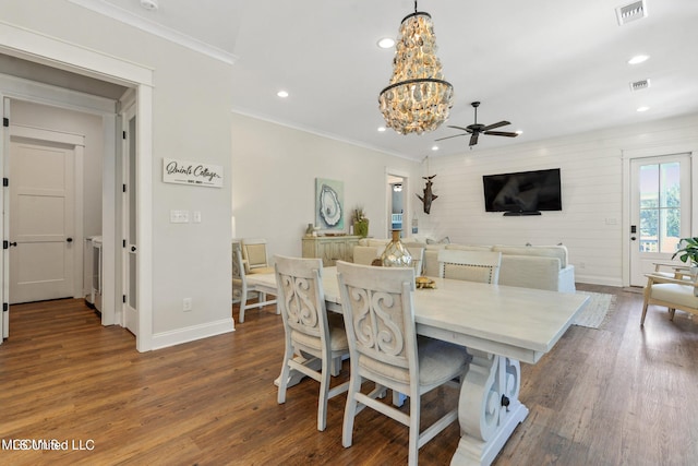 dining area with ceiling fan with notable chandelier, dark hardwood / wood-style floors, and crown molding