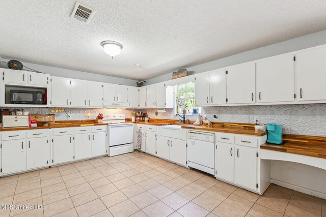 4628 Breland Rd, Vancleave, MS 39565 - kitchen featuring white appliances, exhaust hood, white cabinetry, a textured ceiling, and a sink